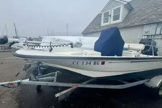 Slide: The Image of 2014 Boston Whaler Montalk boat on trailer in front of building. - 4