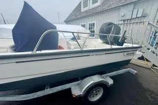 Slide: The Image of 2014 Boston Whaler Montalk boat on trailer near building. - 5