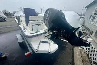 Slide: The Image of 2014 Boston Whaler Montalk boat with outboard motor on trailer. - 6