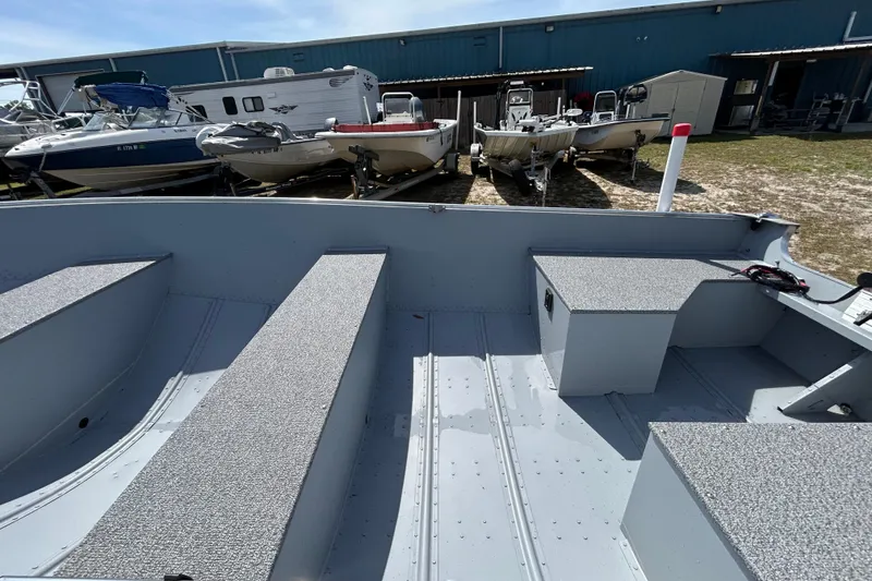 Slide: The Image of Interior view of a 2026 Crestliner 1469 Outreach boat, showcasing seating and storage. - 12