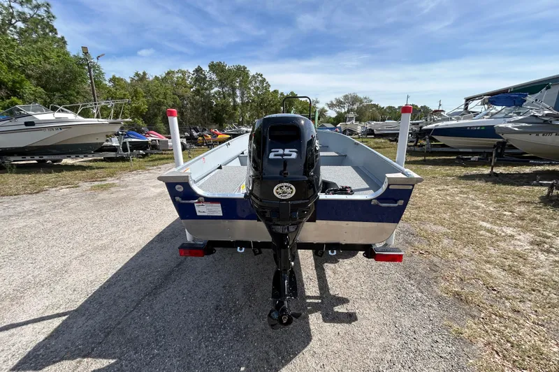 Slide: The Image of 2026 Crestliner 1469 Outreach boat with 25 HP motor in a marina setting. - 3