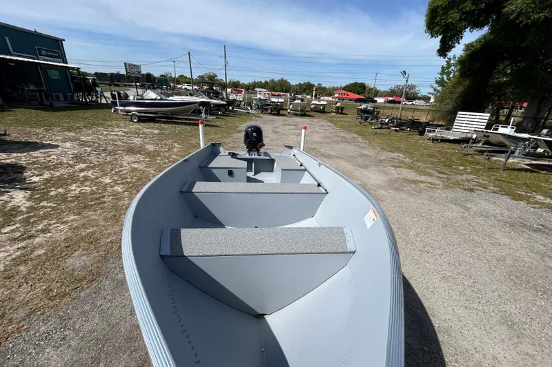 Slide: The Image of 2026 Crestliner 1469 Outreach boat displayed outdoors on a sunny day. - 5