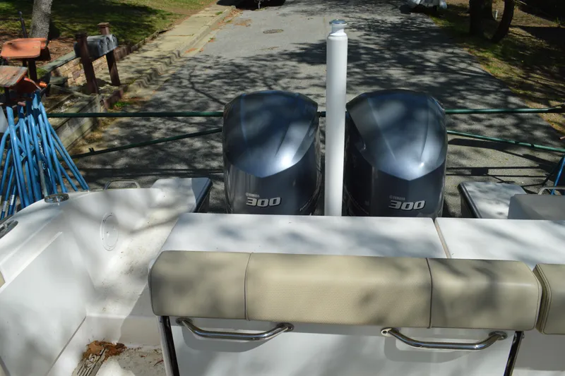 Slide: The Image of 2018 Pursuit DC 295 Dual Console boat with twin Yamaha 300 engines, docked outdoors. - 17
