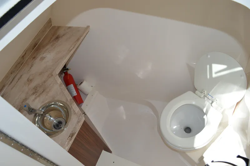 Slide: The Image of 2018 Pursuit DC 295 Dual Console boat bathroom with sink and toilet. - 18