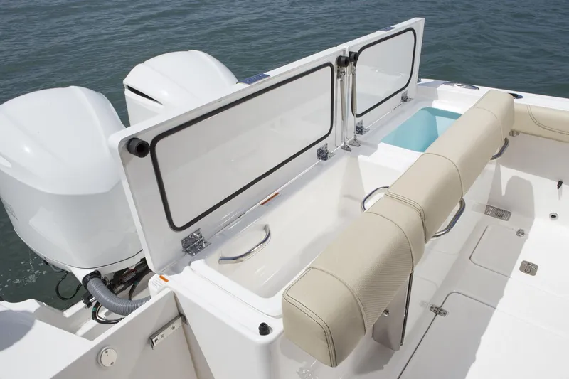 Slide: The Image of Manufacturer Provided Image: 2018 Pursuit DC 295 Dual Console boat with open storage compartments and twin engines. - 19