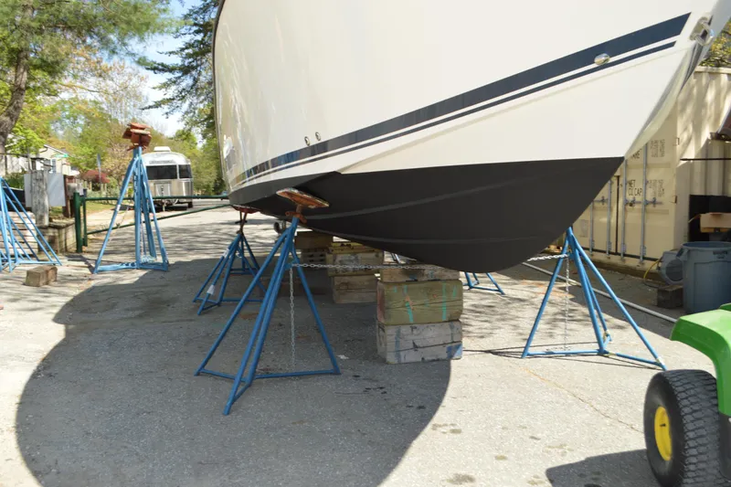 Slide: The Image of 2018 Pursuit DC 295 Dual Console boat on stands in outdoor storage area. - 6