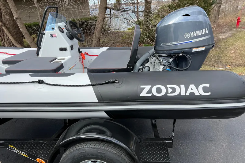 Slide: The Image of 2023 Zodiac Open 4.2 inflatable boat with Yamaha engine on trailer. - 13