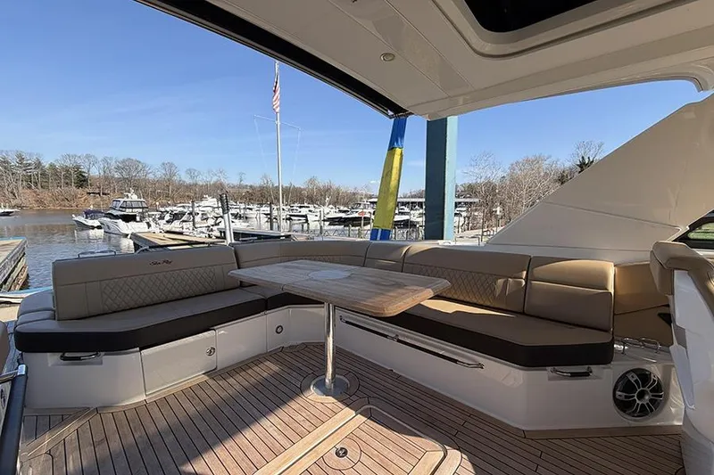 Slide: The Image of Luxurious 2023 Sea Ray SLX 400 yacht with elegant seating and scenic marina view. - 14