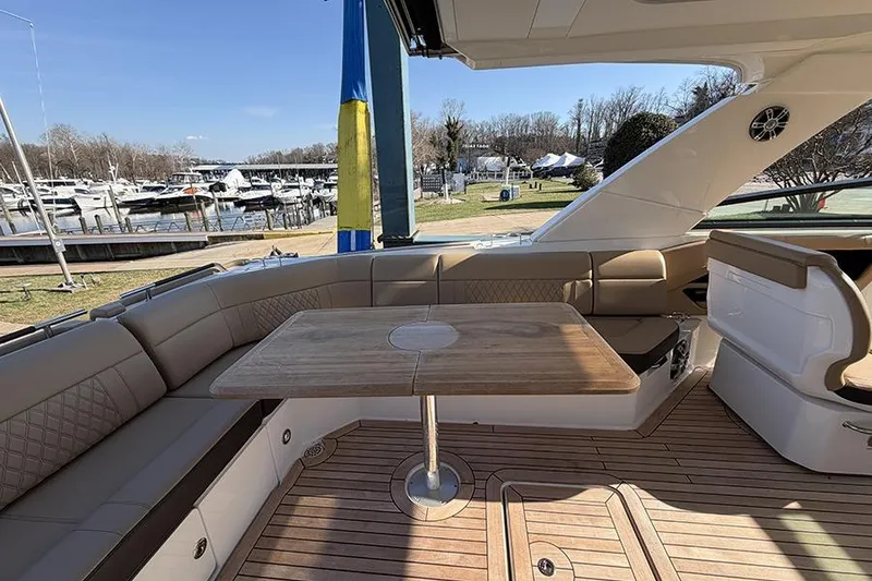 Slide: The Image of 2023 Sea Ray SLX 400 yacht interior with elegant seating and wooden table. - 15