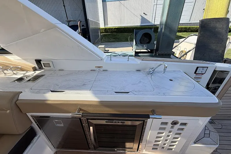 Slide: The Image of Outdoor kitchen area on 2023 Sea Ray SLX 400 yacht with sink and countertop. - 18