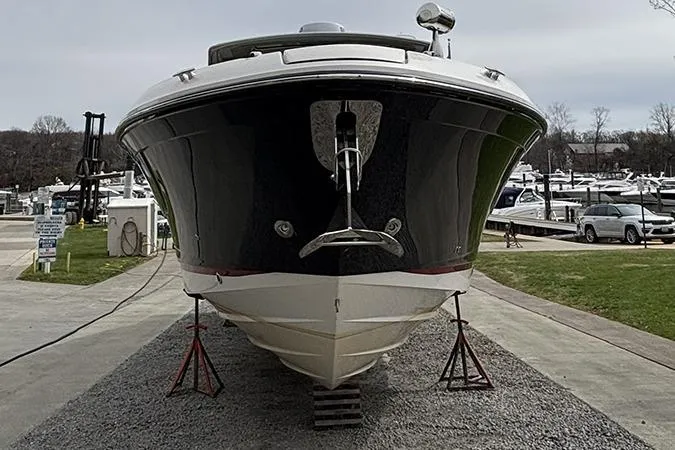 Slide: The Image of 2023 Sea Ray SLX 400 boat on stands at a marina. - 2