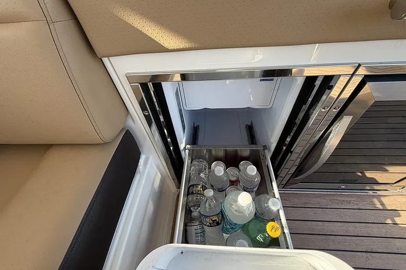Slide: The Image of 2023 Sea Ray SLX 400 boat interior with beverage cooler drawer open. - 20