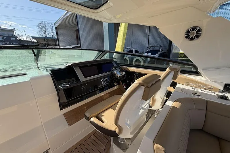 Slide: The Image of Interior view of 2023 Sea Ray SLX 400 boat cockpit with modern controls and seating. - 26