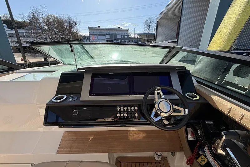 Slide: The Image of 2023 Sea Ray SLX 400 helm with modern controls and dual screens in a marina setting. - 29