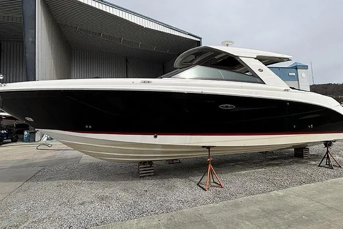 Slide: The Image of 2023 Sea Ray SLX 400 boat on stands in a marina setting. - 3
