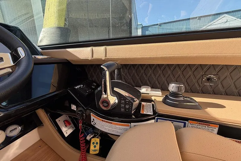 Slide: The Image of 2023 Sea Ray SLX 400 helm with modern controls and luxurious interior design. - 30