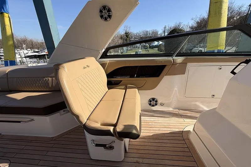 Slide: The Image of 2023 Sea Ray SLX 400 boat interior with tan leather seating and wood flooring. - 31