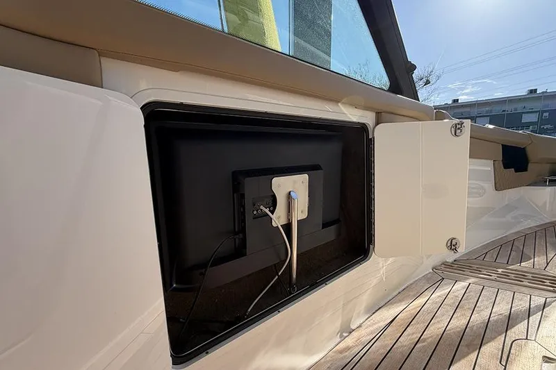 Slide: The Image of 2023 Sea Ray SLX 400 boat interior with open storage compartment and visible wiring. - 33