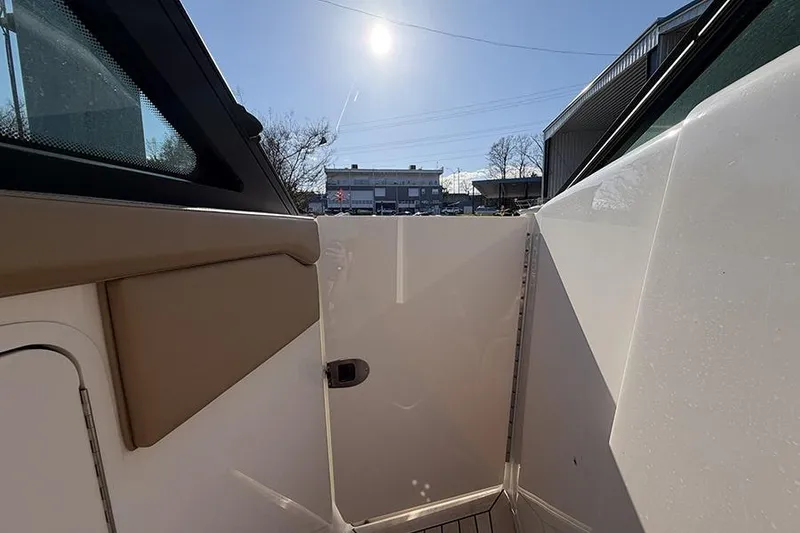 Slide: The Image of 2023 Sea Ray SLX 400 boat interior with sunlight and outdoor view. - 34