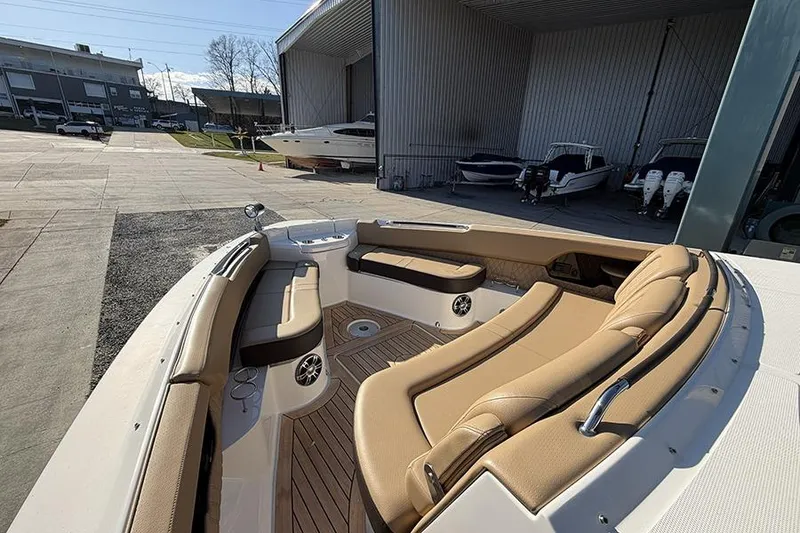 Slide: The Image of 2023 Sea Ray SLX 400 boat with luxurious seating in a marina setting. - 35
