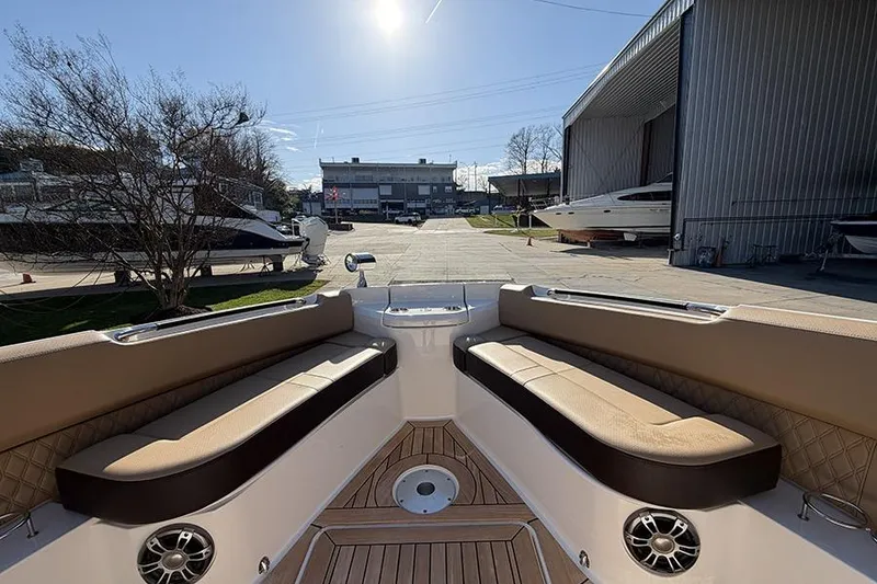 Slide: The Image of 2023 Sea Ray SLX 400 boat interior with cushioned seating and wood flooring. - 38