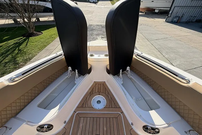 Slide: The Image of 2023 Sea Ray SLX 400 boat interior with teak flooring and seating compartments. - 39