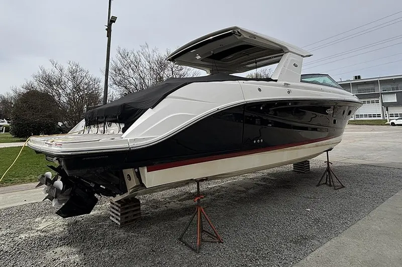 Slide: The Image of 2023 Sea Ray SLX 400 boat on stands, displayed outdoors. - 4