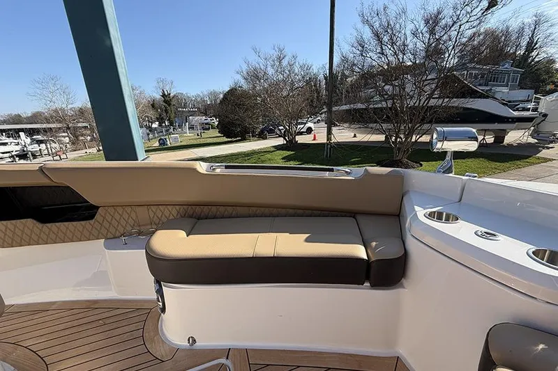 Slide: The Image of 2023 Sea Ray SLX 400 boat interior with tan seating and cup holders. - 40