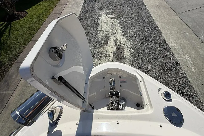 Slide: The Image of Open anchor compartment on 2023 Sea Ray SLX 400 boat, showing anchor mechanism. - 43