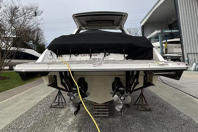 Slide: The Image of 2023 Sea Ray SLX 400 boat docked, rear view with covered deck and dual propellers. - 5