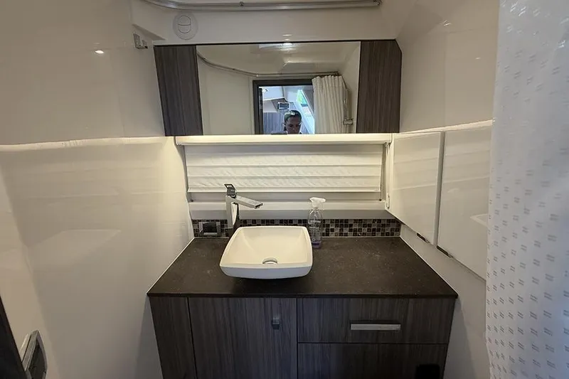Slide: The Image of Modern bathroom interior of 2023 Sea Ray SLX 400 yacht with sleek sink and mirror. - 51
