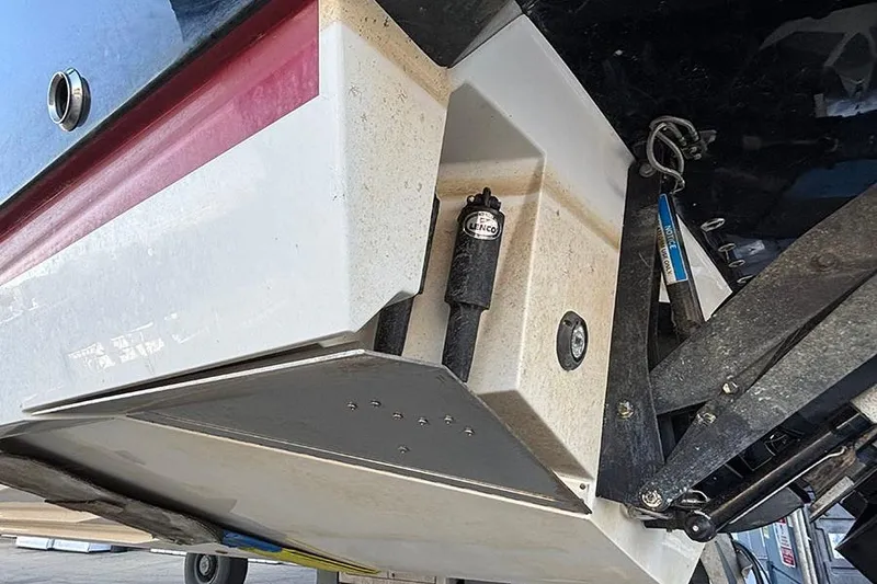 Slide: The Image of 2023 Sea Ray SLX 400 boat hull detail with trim tab and hydraulic components. - 8