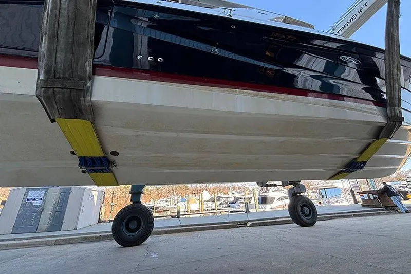 Slide: The Image of 2023 Sea Ray SLX 400 boat lifted for maintenance at a marina. - 9