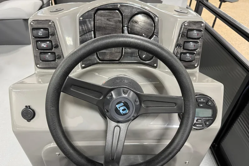 Slide: The Image of Steering console of 2026 Angler Quest 7515 Leisure Quest Cruise boat, featuring control panel and switches. - 6