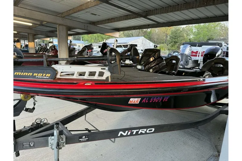 Slide: The Image of 2020 Nitro Z18 boat with Minn Kota Fortrex motor in covered storage. - 2