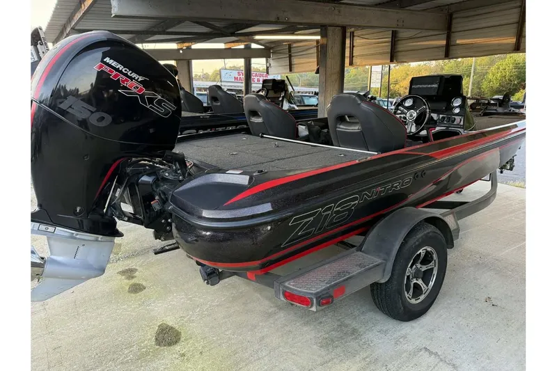 Slide: The Image of 2020 Nitro Z18 boat with Mercury Pro XS engine, parked under a shelter. - 6