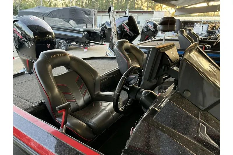 Slide: The Image of Interior of a 2020 Nitro Z18 boat featuring sleek black seats and modern controls. - 65