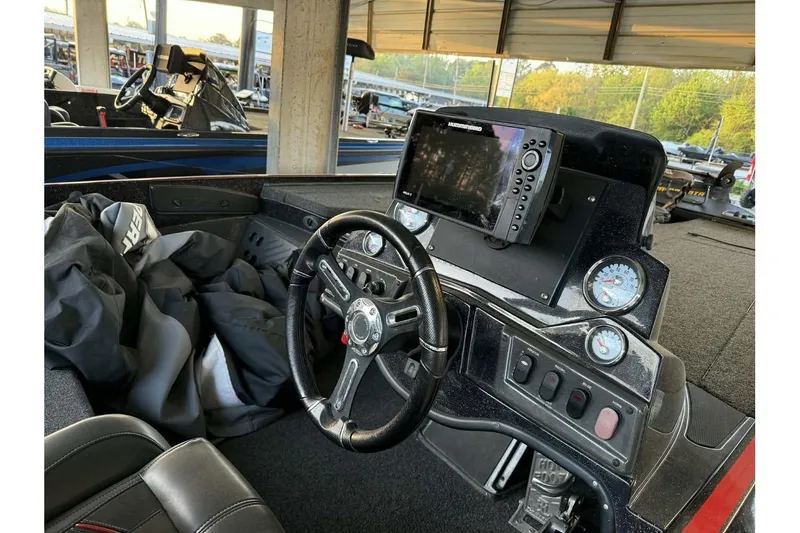 Slide: The Image of Interior of a 2020 Nitro Z18 boat featuring steering wheel and control panel. - 7