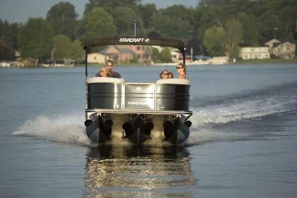 Slide: The Image of Manufacturer Provided Image: 2018 Starcraft SLS 3 pontoon boat cruising on a lake with passengers. - 13