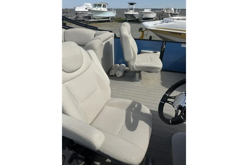 Slide: The Image of 2018 Starcraft SLS 3 boat interior with beige seating and steering wheel. - 4