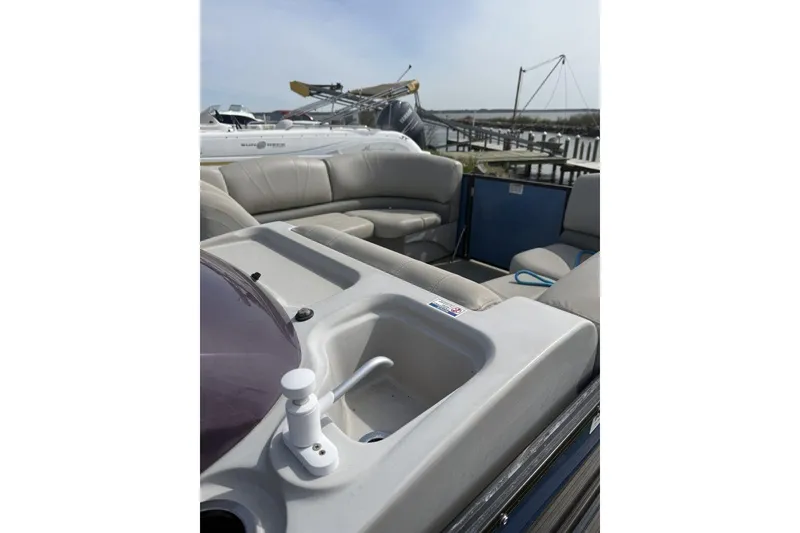 Slide: The Image of 2018 Starcraft SLS 3 boat interior with seating and sink, docked by the water. - 6