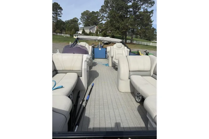 Slide: The Image of 2018 Starcraft SLS 3 pontoon boat interior with beige seating and outdoor setting. - 7