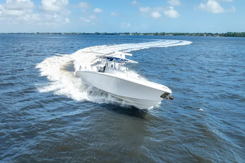 The Image of 2024 Bahama 41 boat cruising on open water under a clear blue sky. - 0