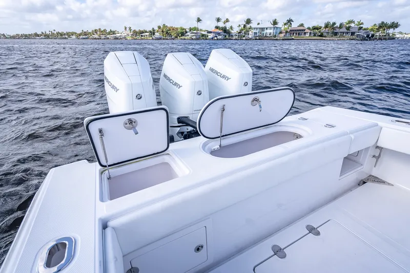 Slide: The Image of 2024 Bahama 41 boat with Mercury engines on a calm water backdrop. - 12