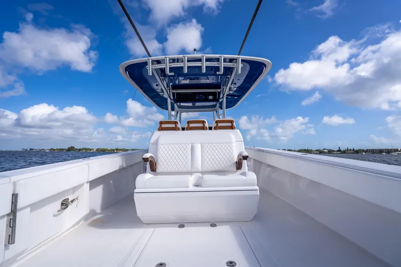 Slide: The Image of 2024 Bahama 41 boat with sleek seating, cruising under a vibrant blue sky. - 15