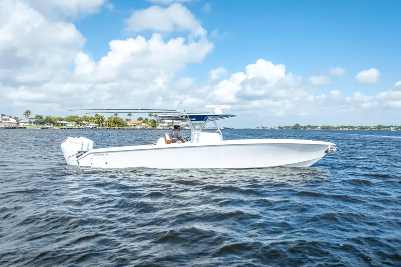 Slide: The Image of 2024 Bahama 41 boat cruising on a sunny day with clear skies and calm waters. - 2