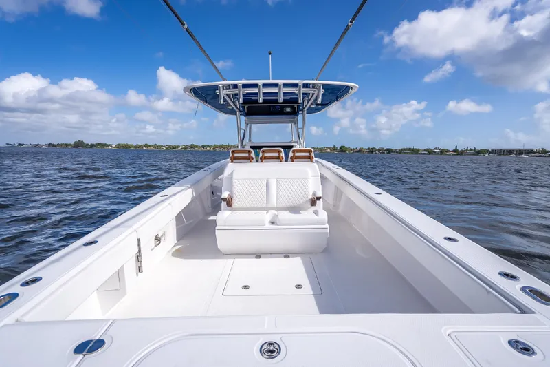 Slide: The Image of 2024 Bahama 41 boat on open water under blue sky with clouds. - 21