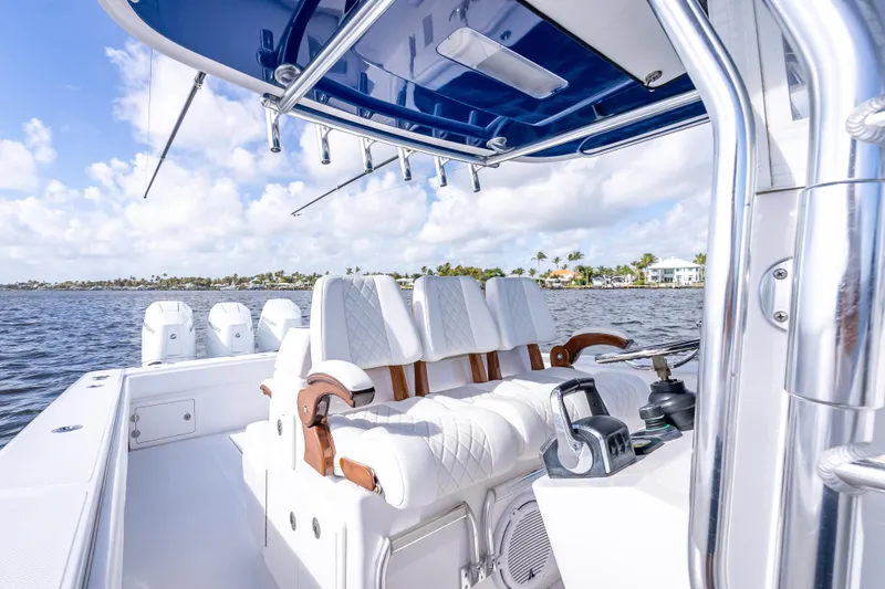 Slide: The Image of 2024 Bahama 41 boat interior with white seating and ocean view. - 22