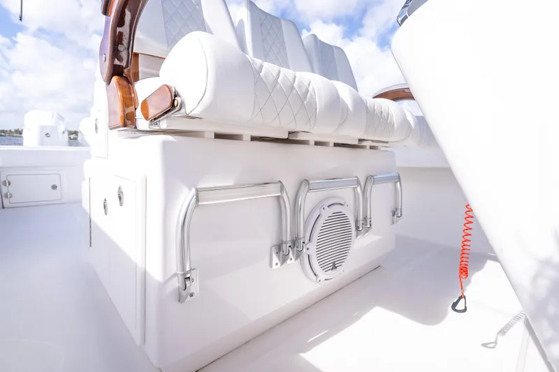 Slide: The Image of Luxury seating on 2024 Bahama 41 boat, featuring white upholstery and stainless steel accents. - 24