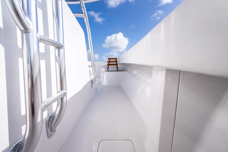 Slide: The Image of 2024 Bahama 41 boat deck with stainless steel railings under a clear blue sky. - 26